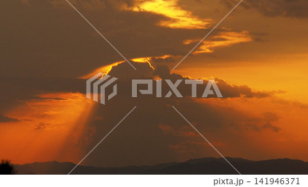 Solar Eclipse, Red Sky and Dramatic Clouds at Sunset Solar Eclipse, Red Sky and Dramatic Clouds at Sunset 141946371
