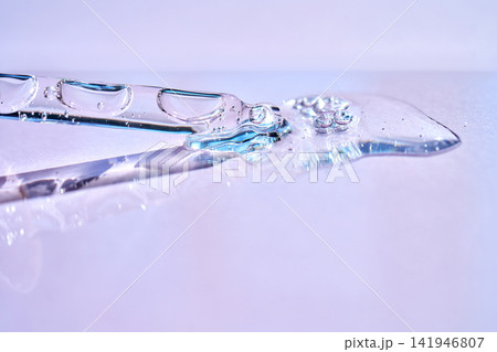 Skincare serum drops from pipette for hydration 141946807