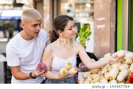 couple choose turnips on the market couple choose turnips on the market 141947764