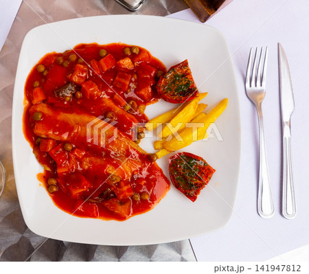 Tilapia fillet with vegetables, french fries and sun-dried tomatoes Tilapia fillet with vegetables, french fries and sun-dried tomatoes 141947812