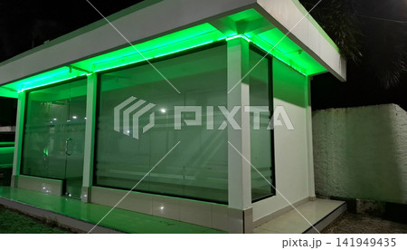 Modern Building Exterior Illuminated with Green LED Strip Light Modern Building Exterior Illuminated with Green LED Strip Light 141949435