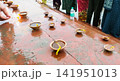 Oil Lamps (Diyas) Lined Along River Ghat During Ritual in Mathura 141951013