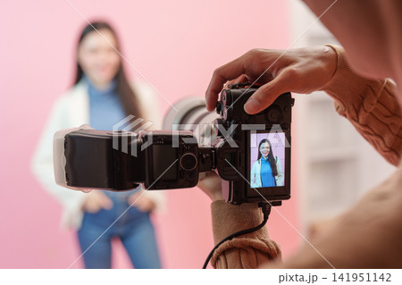 Camera screen displaying portrait preview of female model during photoshoot in studio Camera screen displaying portrait preview of female model during photoshoot in studio 141951142