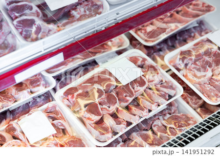 Raw lamb meat in packages on display in butcher shop 141951292