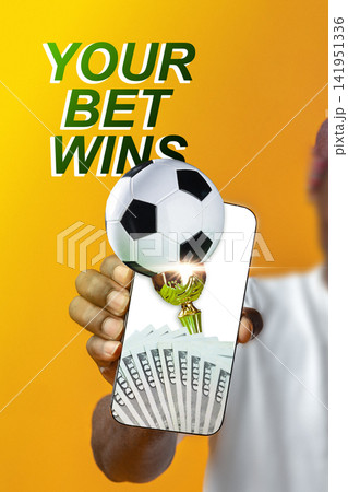 Winning sports bet on a mobile device with soccer ball and cash displayed Winning sports bet on a mobile device with soccer ball and cash displayed 141951336