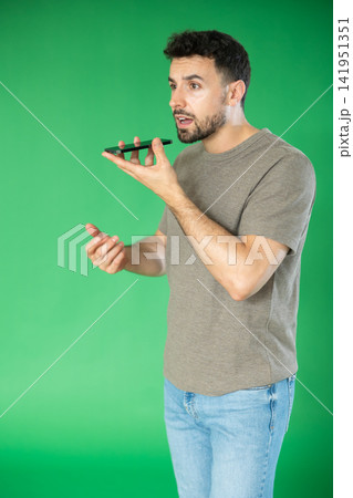 Man records voice message using voice recorder or communicates with voice messages 141951351