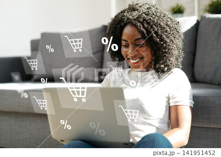 Shopping online from home with a laptop and looking for deals Shopping online from home with a laptop and looking for deals 141951452