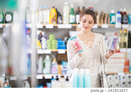 Young woman choosing razor in retail store Young woman choosing razor in retail store 141951657
