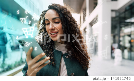 Woman using smartphone for online shopping in a mall during daytime Woman using smartphone for online shopping in a mall during daytime 141951746