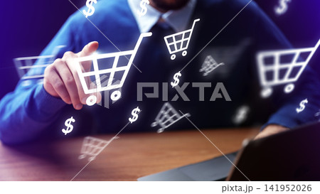 Shopping online with a laptop and digital shopping carts at home in the evening Shopping online with a laptop and digital shopping carts at home in the evening 141952026