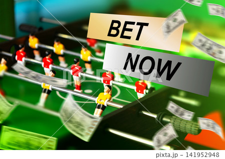 Sport betting scene with cash and foosball table at a local bar during a game night 141952948