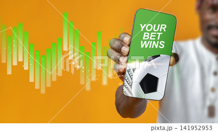 Sports betting success with a mobile phone showing winning bet and soccer ball 141952953