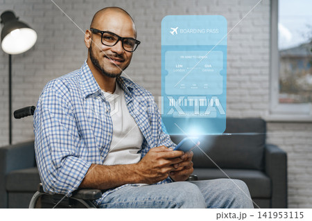Man using phone to book travel with digital boarding pass on screen inside home environment Man using phone to book travel with digital boarding pass on screen inside home environment 141953115