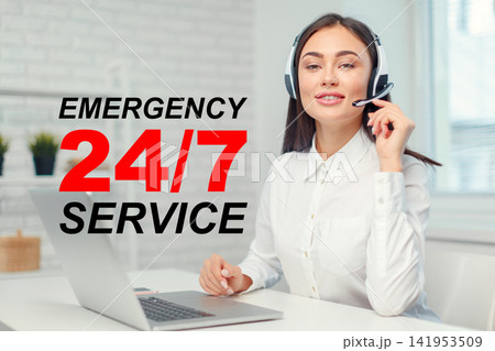 Emergency service operator working at a desk with a headset and laptop while providing support round the clock Emergency service operator working at a desk with a headset and laptop while providing support round the clock 141953509
