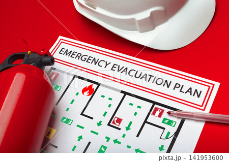 Emergency evacuation plan with fire extinguisher and hard hat on red background shows safety preparation for emergency Emergency evacuation plan with fire extinguisher and hard hat on red background shows safety preparation for emergency 141953600