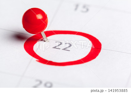 Important date marked with a pin on a calendar for the 22nd day of the month Important date marked with a pin on a calendar for the 22nd day of the month 141953885