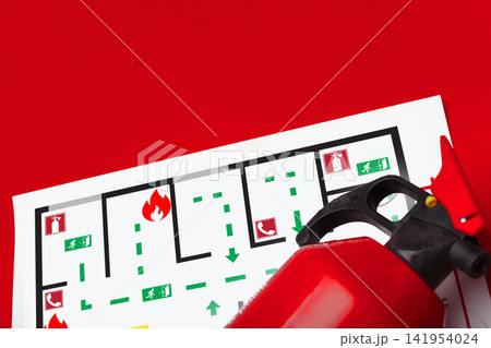 Emergency 911 plan with fire extinguisher and escape route map on red background in office setting 141954024