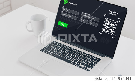 Online payment process on a laptop with a QR code displayed on the screen 141954341