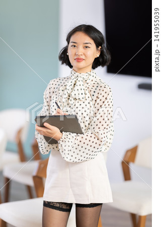 Portrait of female teacher with an electronic tablet in her hands Portrait of female teacher with an electronic tablet in her hands 141955039