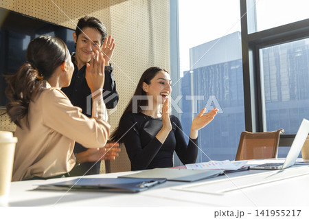 Business meeting in an office, use tablet computer and celebrate success together at office. Business meeting in an office, use tablet computer and celebrate success together at office. 141955217