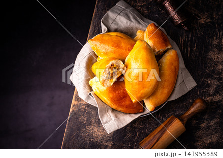 Traditional baked pies pirozhki with meat. 141955389