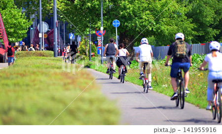 Warsaw, Poland. 25 July 2026. Cyclists on the urban bike path in the city Warsaw, Poland. 25 July 2026. Cyclists on the urban bike path in the city 141955916