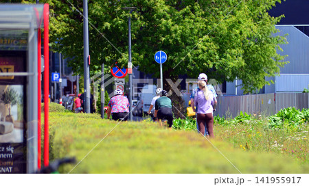 Warsaw, Poland. 25 July 2026. Cyclists on the urban bike path in the city Warsaw, Poland. 25 July 2026. Cyclists on the urban bike path in the city 141955917