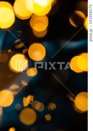 Vertical macro of multi colored christmas bokeh lights on dark background Vertical macro of multi colored christmas bokeh lights on dark background 141956573