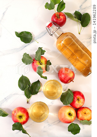 Apple cider with fruit in baskets, Thanksgiving decorations and country harvest, healthy natural food and home canning concept, longterm storage at home, banner for a screen, business card for a cafe Apple cider with fruit in baskets, Thanksgiving decorations and country harvest, healthy natural food and home canning concept, longterm storage at home, banner for a screen, business card for a cafe 141962289