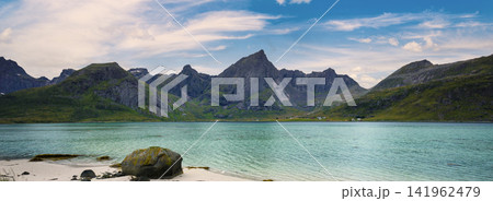Fjord at sunset in rainy day, Rocky beach in evening, Beach with white sand. Beautiful nature of Norway. Lofoten islands Fjord at sunset in rainy day, Rocky beach in evening, Beach with white sand. Beautiful nature of Norway. Lofoten islands 141962479