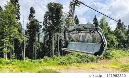 Empty chairlift above a mountain forest in summer 141962820