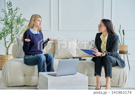 Teenage girl talking to female school psychologist Teenage girl talking to female school psychologist 141963174