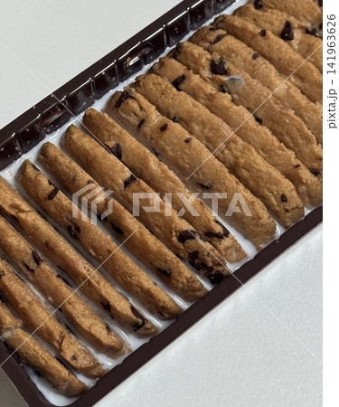 Cookies being enjoyed with a glass of milk, featuring a soft bite and rich sweetness balanced by creamy freshness. A cozy, nostalgic moment that feels warm, simple, and comforting. Cookies being enjoyed with a glass of milk, featuring a soft bite and rich sweetness balanced by creamy freshness. A cozy, nostalgic moment that feels warm, simple, and comforting. 141963626