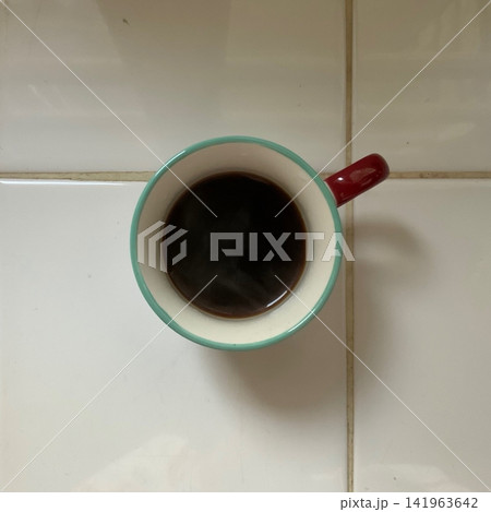 Freshly brewed black coffee with a deep aroma and bold, rich flavor. Smooth and comforting, capturing a quiet moment of warmth and focus in every sip. 141963642
