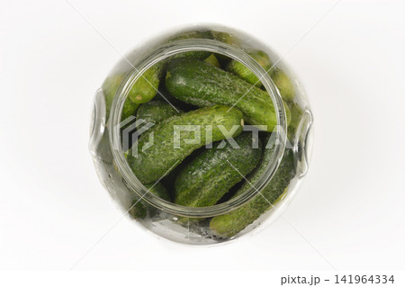 Top view of a glass jar packed with green gherkins Top view of a glass jar packed with green gherkins 141964334