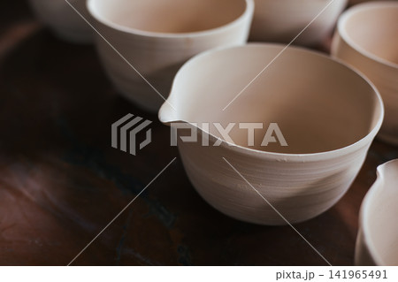 The process of creating pottery. 141965491