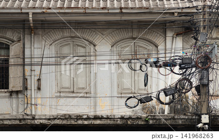 Historic Bangkok Architecture Framed and Tangled Utility Wires Lies in Bangkok, Timeless Colonial Architecture Meets Modern Cable Web. Historic Bangkok Architecture Framed and Tangled Utility Wires Lies in Bangkok, Timeless Colonial Architecture Meets Modern Cable Web. 141968263