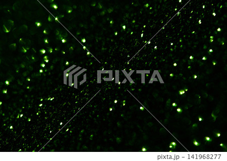 Green Glitter Particles Scattered Across Dark Surface With Tiny Bright Highlights And Dense Shallow 141968277