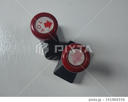 Two red rubber stamps with arrow signs Two red rubber stamps with arrow signs 141968556