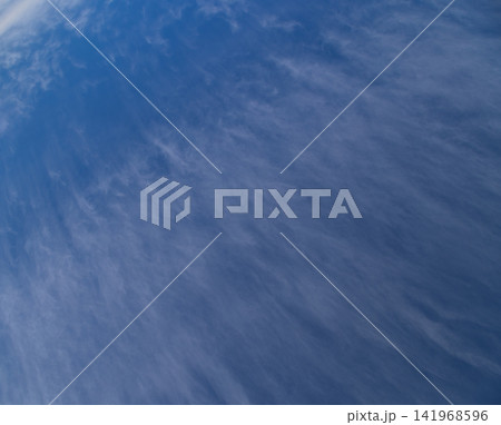 Wispy Cirrus Clouds Streaking Across a Deep Blue Sky Wispy Cirrus Clouds Streaking Across a Deep Blue Sky 141968596
