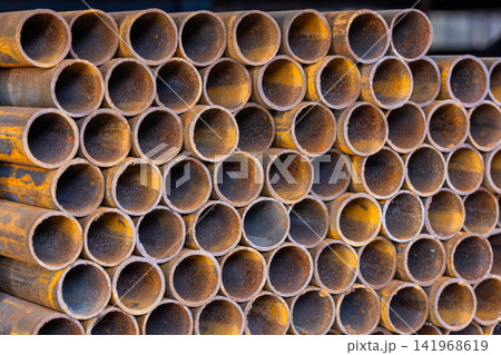Close-up of Stacked Rusty Metal Pipes 141968619