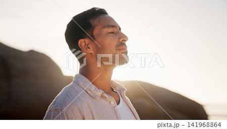 Man, mindfulness or breathing at beach for calm, wellness and summer vacation with flare. Space, peace and person by sea with meditation, nature and awareness mindset with travel to coast for sunrise Man, mindfulness or breathing at beach for calm, wellness and summer vacation with flare. Space, peace and person by sea with meditation, nature and awareness mindset with travel to coast for sunrise 141968864
