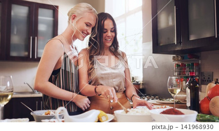 Lesbian, couple or kitchen or happy with dinner for family, food for cooking or holidays. Female chefs or meal with lgbt partner in home and together, relax with smile or love with celebration Lesbian, couple or kitchen or happy with dinner for family, food for cooking or holidays. Female chefs or meal with lgbt partner in home and together, relax with smile or love with celebration 141968930