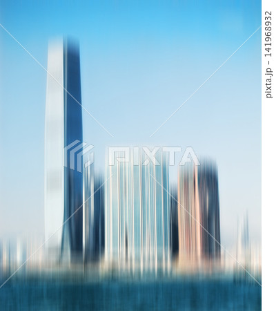 City, buildings and motion blur with skyscraper for background, architecture and urban structure. Blue sky, empty and town with daylight for travel destination, construction and development in Dubai City, buildings and motion blur with skyscraper for background, architecture and urban structure. Blue sky, empty and town with daylight for travel destination, construction and development in Dubai 141968932