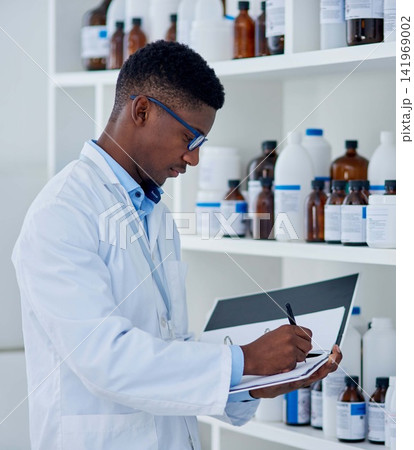 Black man, scientist and folder for inventory in lab for medical stock, update and products checklist. Doctor writing, pharmacist or bottles with chemical supply for research on paper or report 141969002