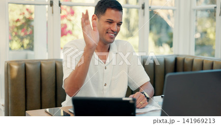 Man, video call and happy with laptop in cafe for wave hello, business consulting and advice with remote work. Person, consultant and freelancer with smile, contact and networking in coffee shop Man, video call and happy with laptop in cafe for wave hello, business consulting and advice with remote work. Person, consultant and freelancer with smile, contact and networking in coffee shop 141969213