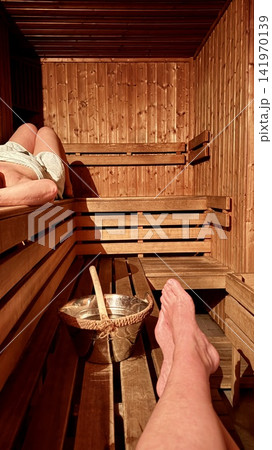 Relaxing sauna interior with wooden benches steam and wellness atmosphere 141970139