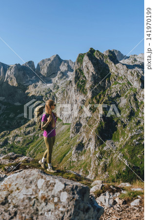 Woman Hiker with Backpack Enjoying Slow Travel Woman Hiker with Backpack Enjoying Slow Travel 141970199