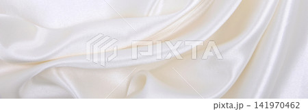 Smooth elegant white silk or satin luxury cloth texture as wedding background. Luxurious background design Smooth elegant white silk or satin luxury cloth texture as wedding background. Luxurious background design 141970462
