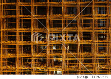 Close-Up of Rusted Metal Mesh Reinforcement Grid 141970559